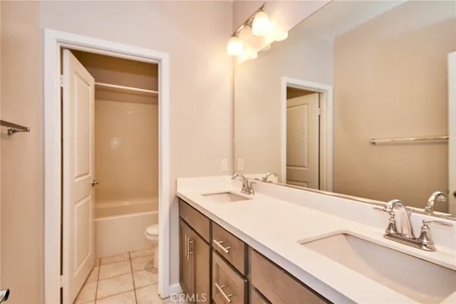 a bathroom with a sink a vanity and shower