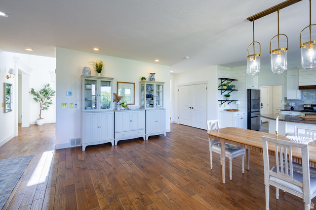 868 Braddock Lane Alpine, UT 84004 - Photo 20 of 64 Expansive wood-finish flooring throughout, complemented by recessed lighting and a contemporary chandelier