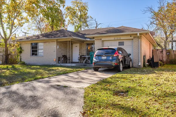 a view of a car parked in front of a house