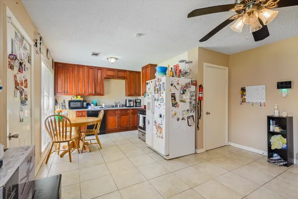 a view of a kitchen with furniture and a ceiling fan