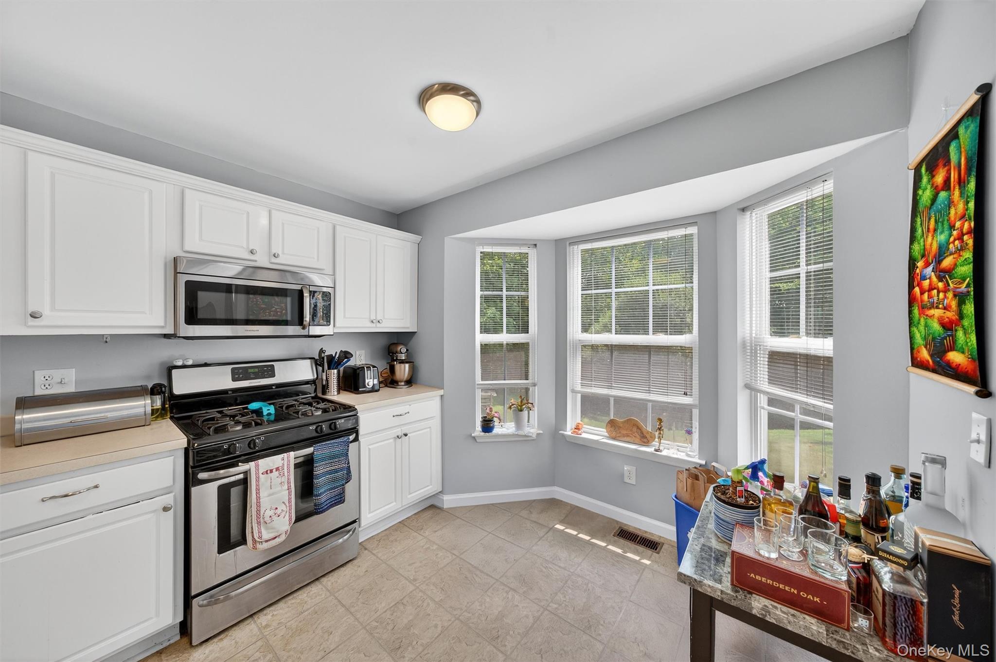 1 Lake Ridge Drive Middletown, NY 10940 - Photo 13 of 44 a kitchen with stainless steel appliances a stove a sink and a refrigerator