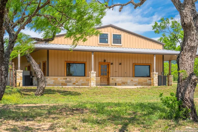 a house that has a tree in front of it
