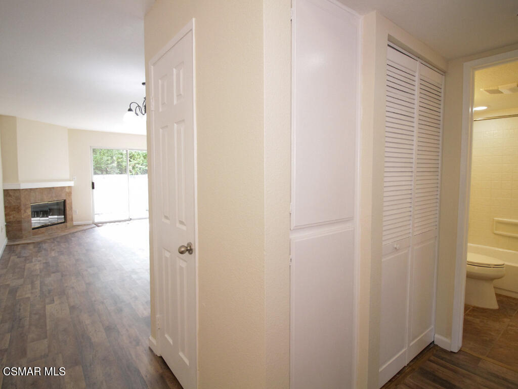 2731 Erringer Road, Unit 79 Simi Valley, CA 93065 - Photo 5 of 13 a view of a hallway with wooden floor and a bathroom