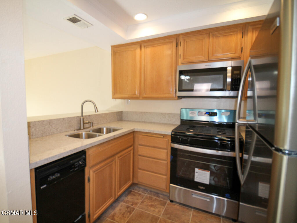 2731 Erringer Road, Unit 79 Simi Valley, CA 93065 - Photo 6 of 13 a kitchen with a sink stove and microwave