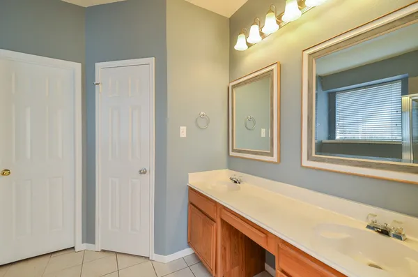 a bathroom with a tub sink and mirror