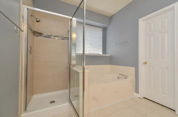 a bathroom with a bathtub and a shower