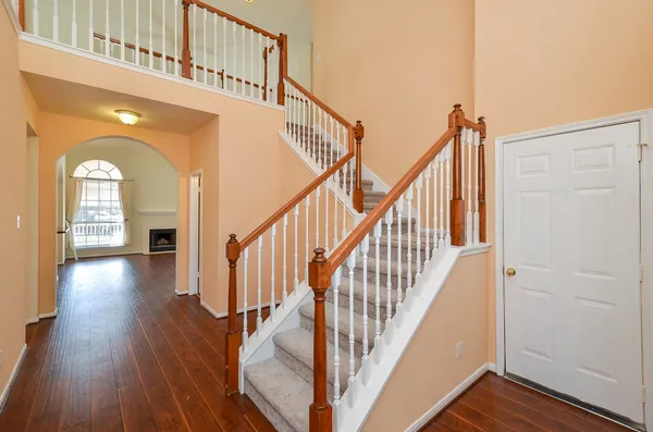 a view of entryway and hall with wooden floor