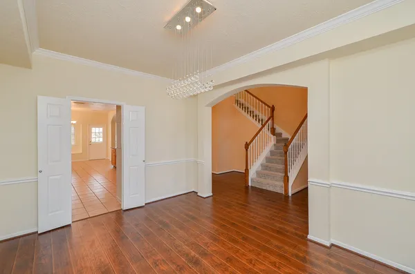 wooden floor in an empty room with a window