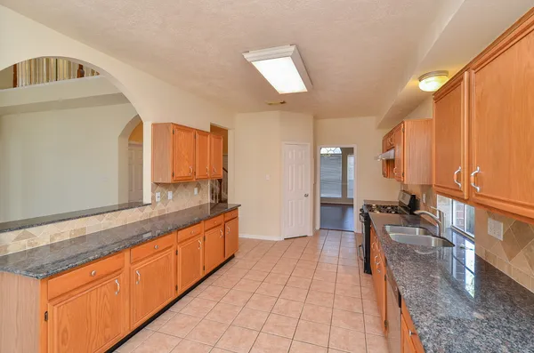 a kitchen with stainless steel appliances granite countertop a sink and cabinets