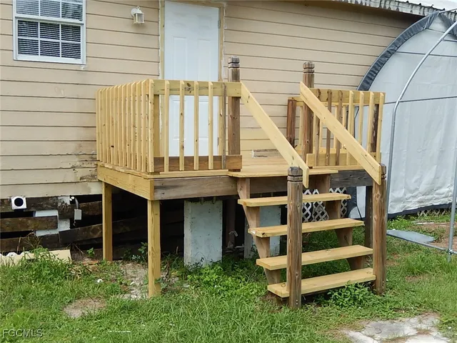 a view of a balcony with furniture and wooden floor