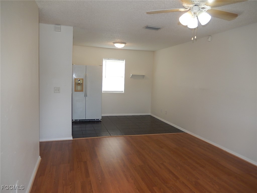 3309 2nd Street Southwest Lehigh Acres, FL 33976 - Photo 3 of 17 an empty room with wooden floor and windows