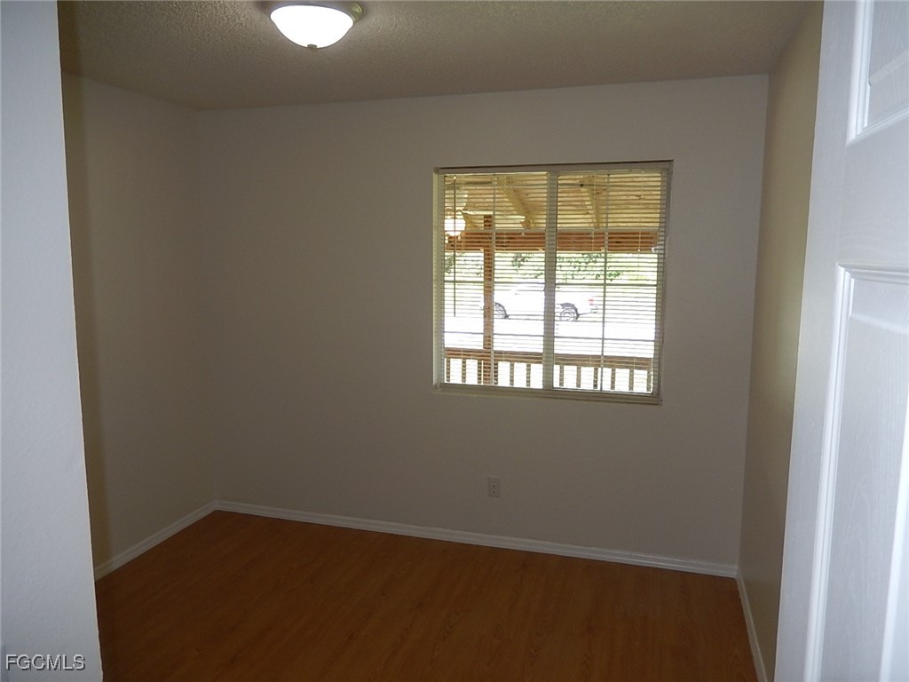 3309 2nd Street Southwest Lehigh Acres, FL 33976 - Photo 8 of 17 an empty room with a window