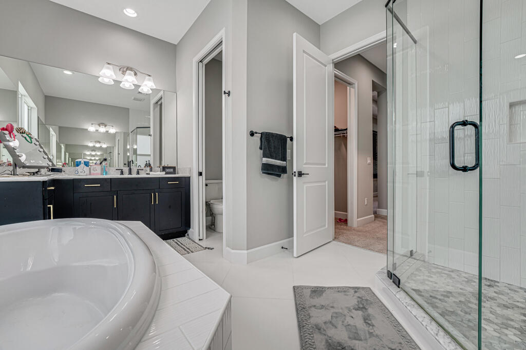 5482 Macoon Way Westlake, FL 33470 - Photo 12 of 69 a large bathroom with a tub and shower