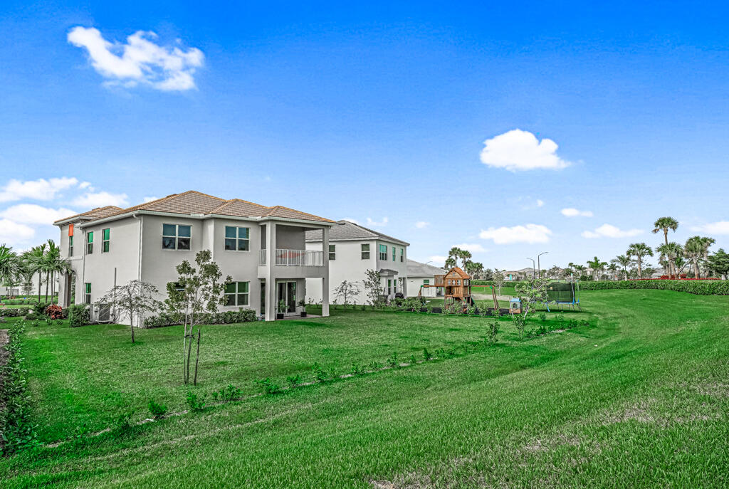 5482 Macoon Way Westlake, FL 33470 - Photo 14 of 69 a front view of a house with garden