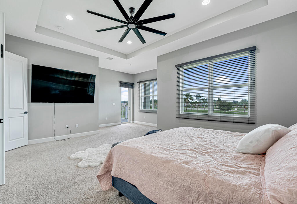 5482 Macoon Way Westlake, FL 33470 - Photo 20 of 69 a bedroom with a bed tv and window
