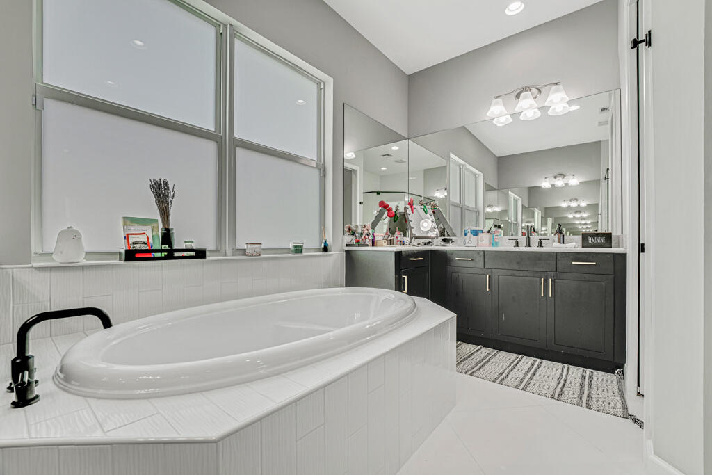 5482 Macoon Way Westlake, FL 33470 - Photo 22 of 69 a bathroom with a sink a vanity and a mirror