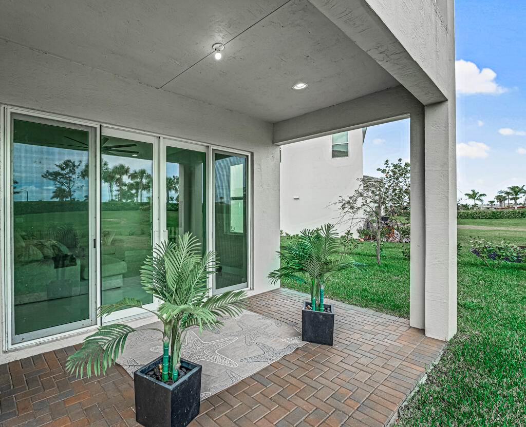 5482 Macoon Way Westlake, FL 33470 - Photo 26 of 69 a potted plant sitting in front of a house