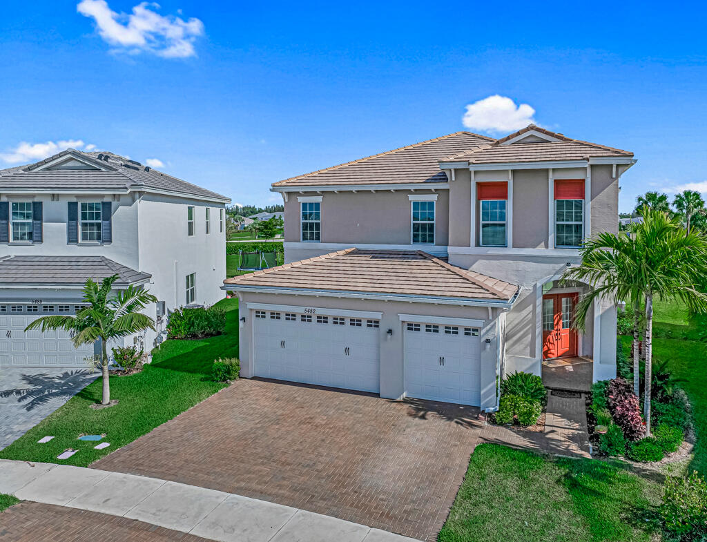 5482 Macoon Way Westlake, FL 33470 - Photo 30 of 69 a view of a house with a yard and potted plants