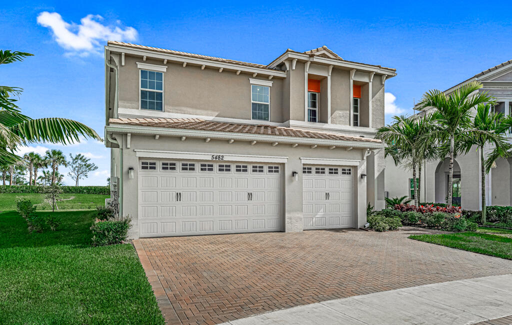 5482 Macoon Way Westlake, FL 33470 - Photo 33 of 69 a front view of a house with a yard and garage