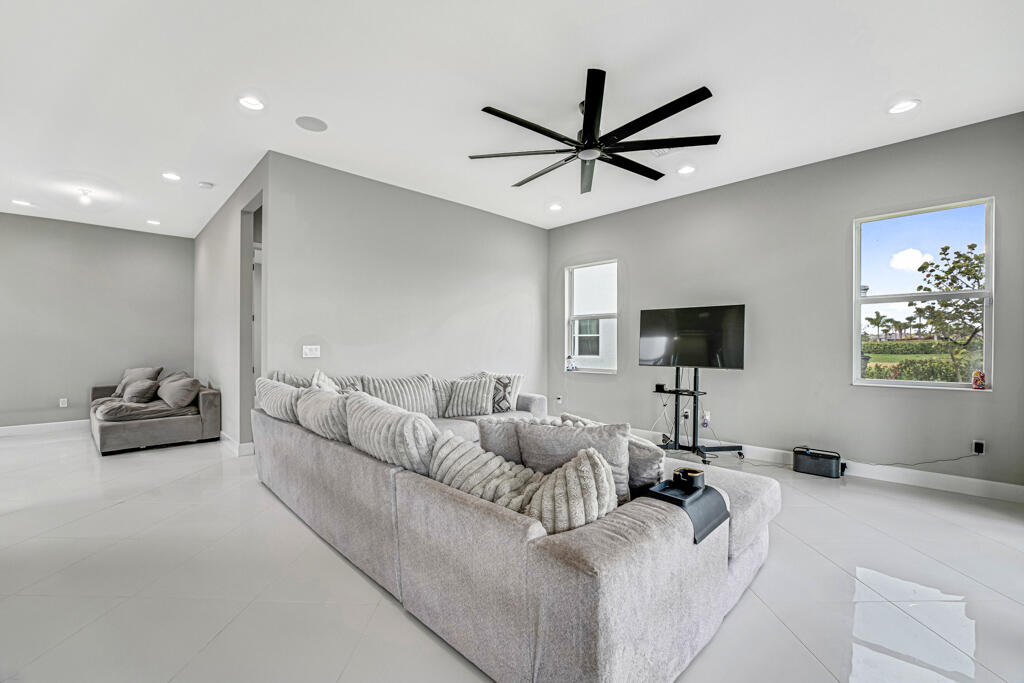 5482 Macoon Way Westlake, FL 33470 - Photo 34 of 69 a living room with furniture and a flat screen tv