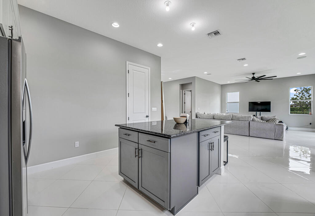 5482 Macoon Way Westlake, FL 33470 - Photo 36 of 69 a kitchen with stainless steel appliances a sink stove and cabinets