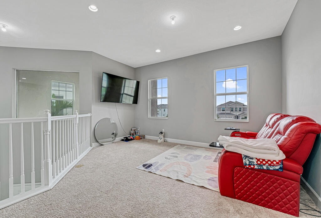 5482 Macoon Way Westlake, FL 33470 - Photo 37 of 69 a bedroom with furniture and a flat screen tv