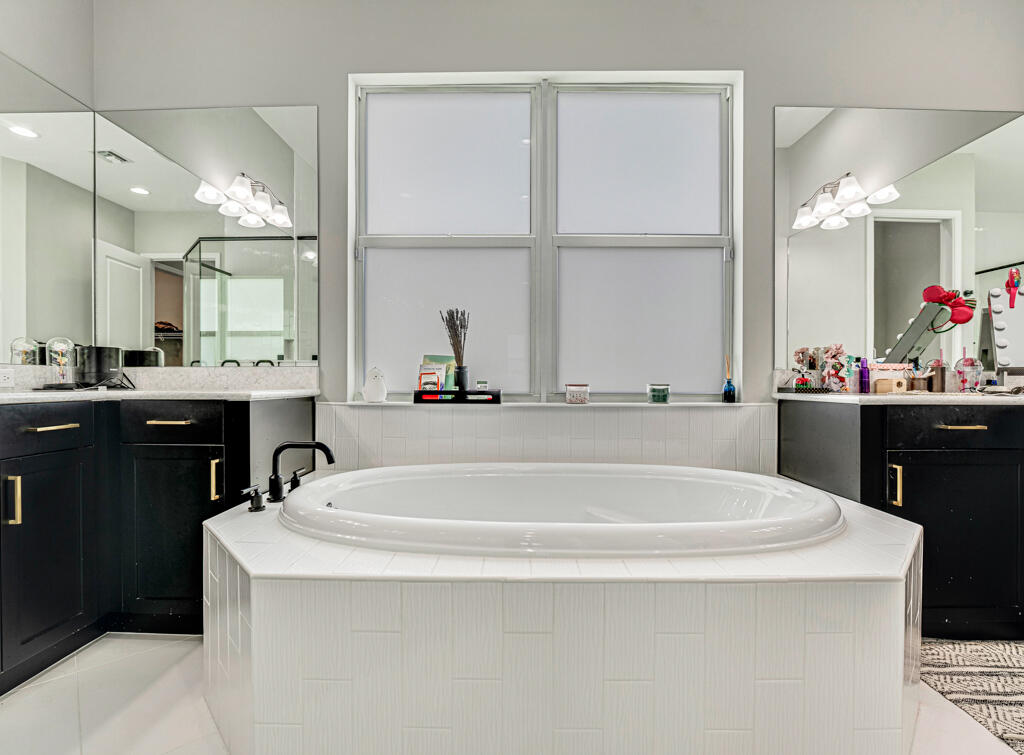 5482 Macoon Way Westlake, FL 33470 - Photo 39 of 69 a spacious bathroom with a tub a sink and a window