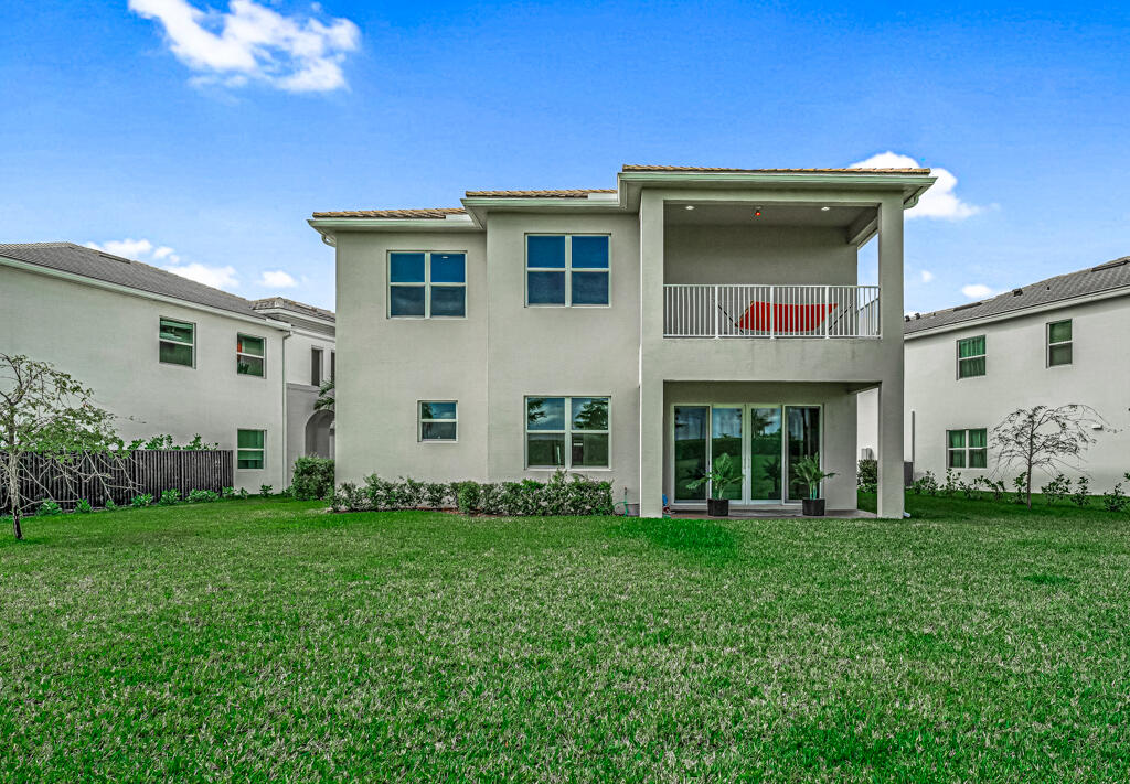 5482 Macoon Way Westlake, FL 33470 - Photo 43 of 69 a front view of a house with a garden