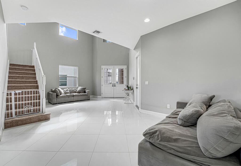 5482 Macoon Way Westlake, FL 33470 - Photo 49 of 69 a living room with furniture and a large mirror