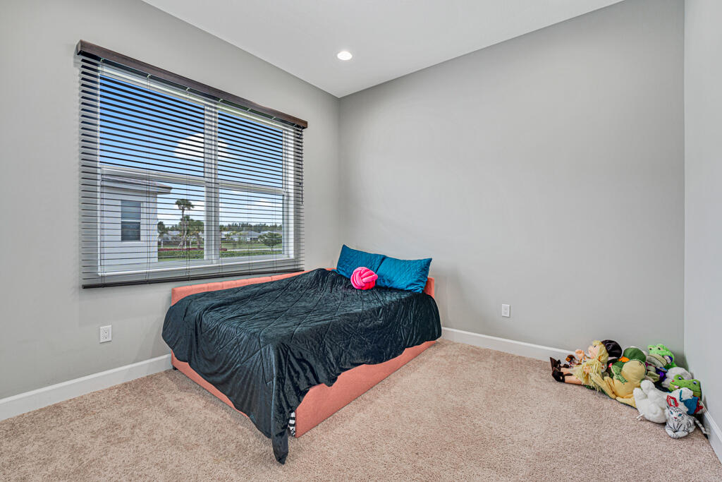 5482 Macoon Way Westlake, FL 33470 - Photo 59 of 69 a bedroom with a bed and a window