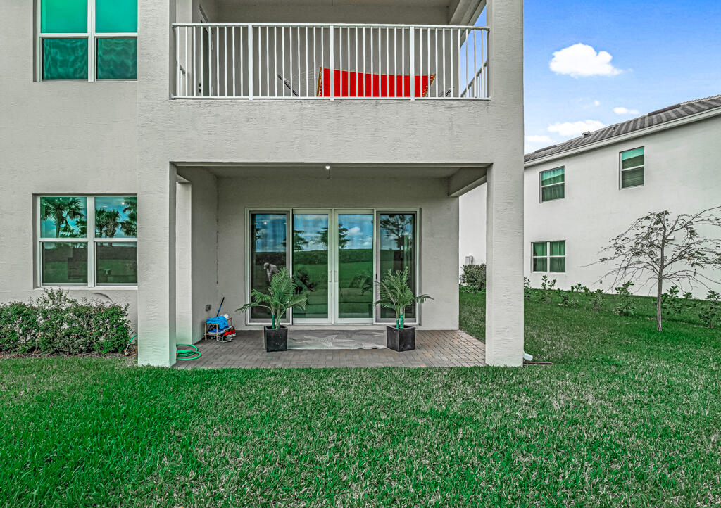 5482 Macoon Way Westlake, FL 33470 - Photo 62 of 69 a front view of a house with a yard