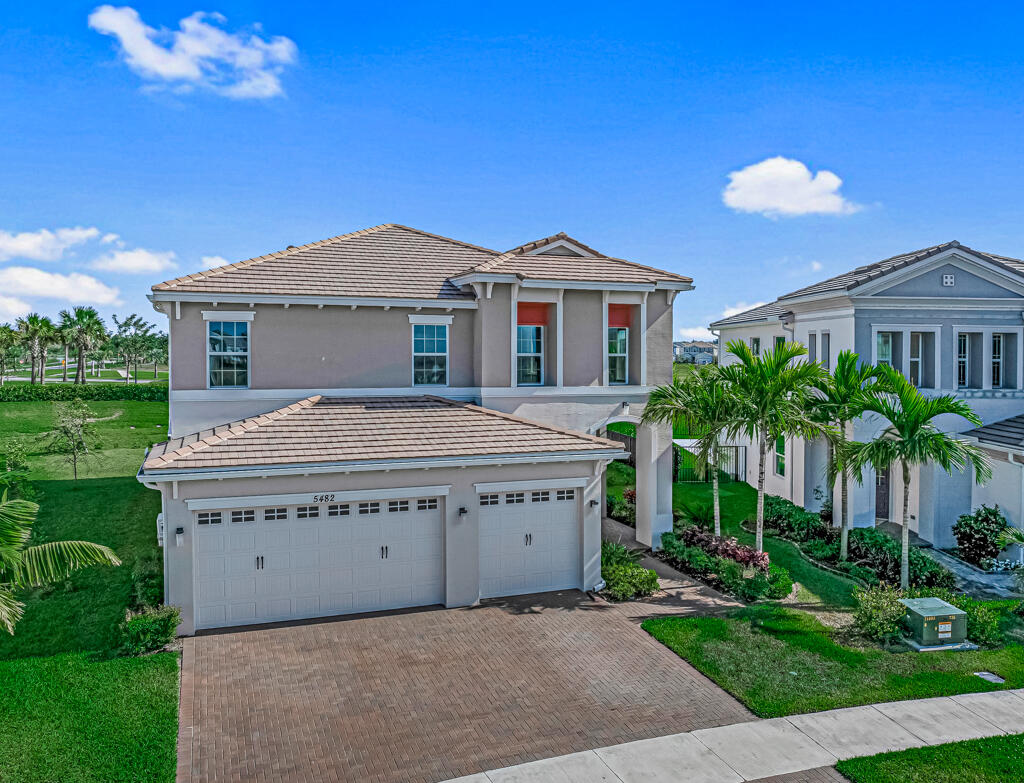 5482 Macoon Way Westlake, FL 33470 - Photo 65 of 69 a view of a house with a yard and potted plants
