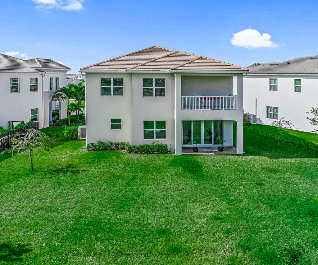 5482 Macoon Way Westlake, FL 33470 - Photo 66 of 69 a view of an house with backyard porch and garden