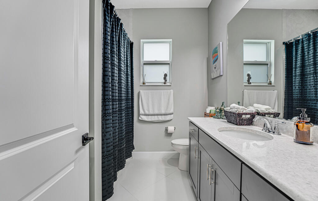 5482 Macoon Way Westlake, FL 33470 - Photo 69 of 69 a bathroom with a sink a toilet and shower