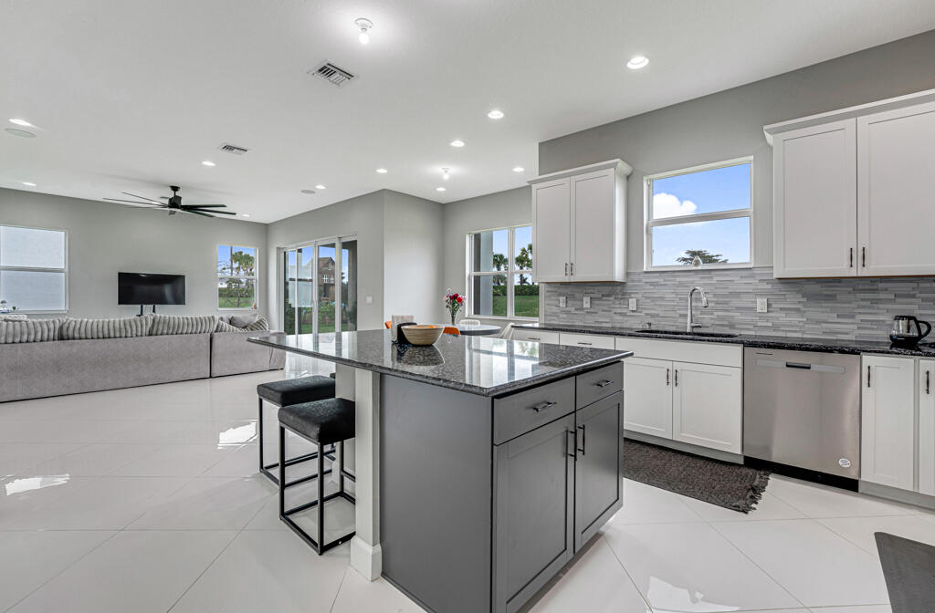 5482 Macoon Way Westlake, FL 33470 - Photo 9 of 69 a kitchen with stainless steel appliances granite countertop a sink and a stove