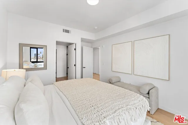 a bedroom with a bed and a painting