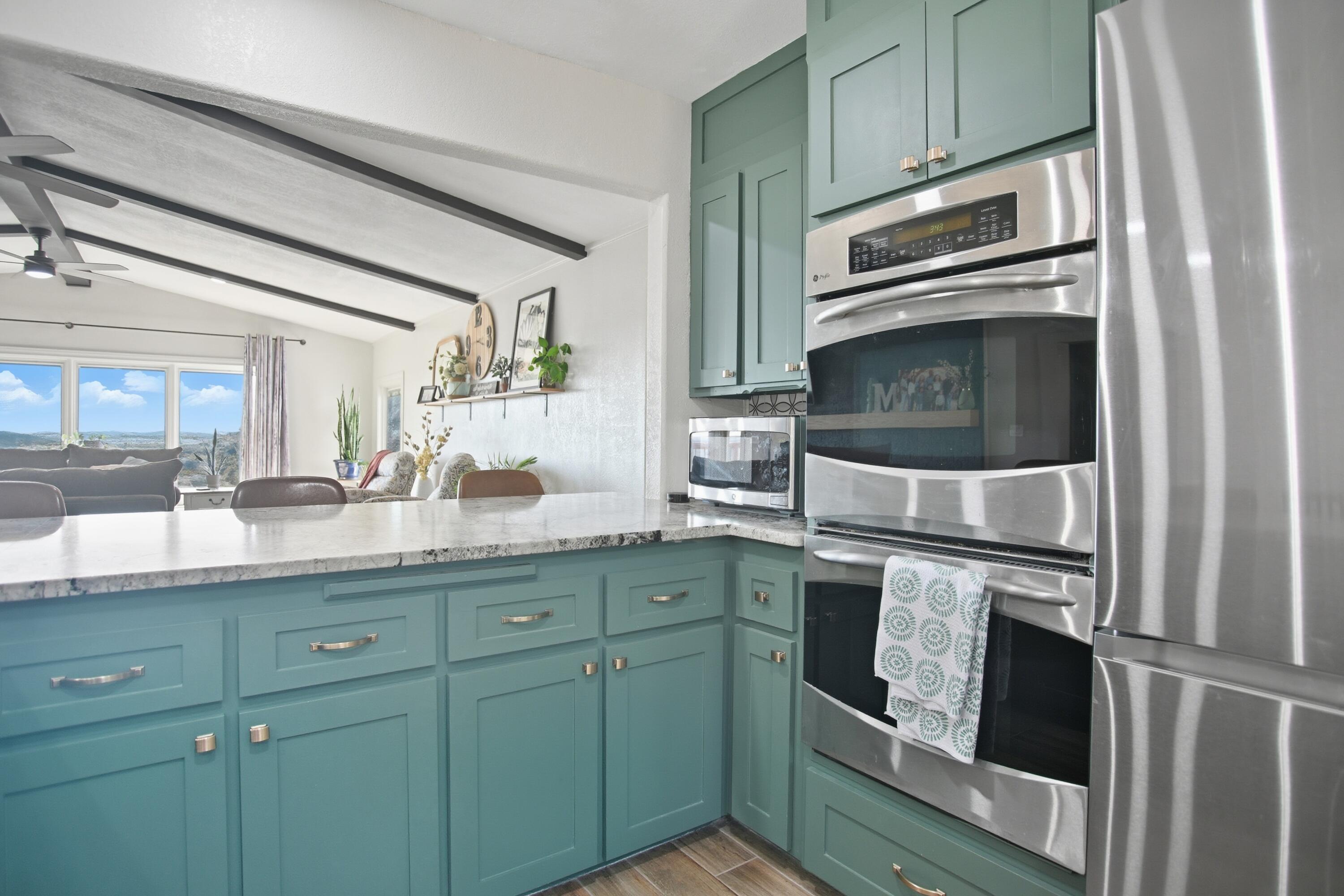 25 East Canyonview Drive Ransom Canyon, TX 79366 - Photo 18 of 58 a kitchen with granite countertop stainless steel appliances and cabinets