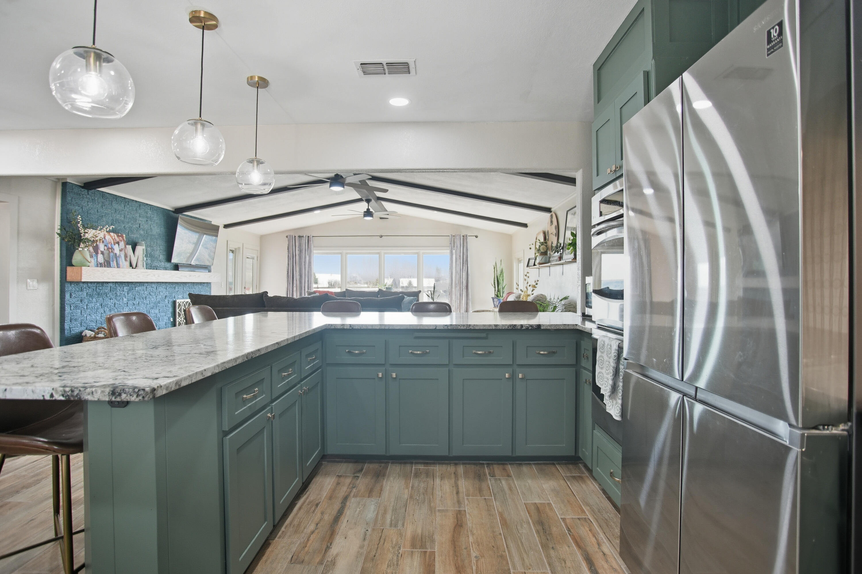 25 East Canyonview Drive Ransom Canyon, TX 79366 - Photo 19 of 58 a kitchen with stainless steel appliances granite countertop a refrigerator a oven and a sink with wooden floor