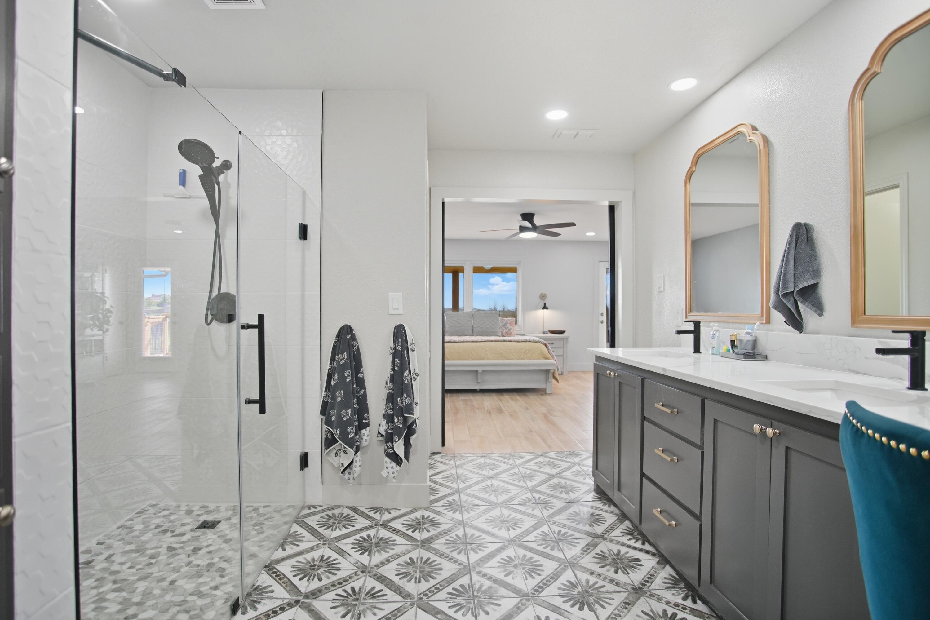 25 East Canyonview Drive Ransom Canyon, TX 79366 - Photo 28 of 58 a bathroom with a double vanity sink mirror and shower