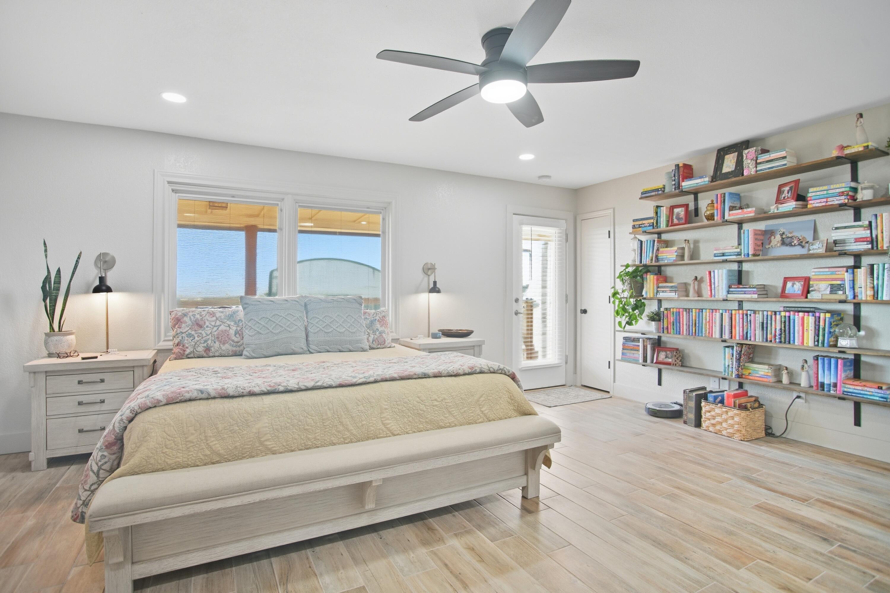 25 East Canyonview Drive Ransom Canyon, TX 79366 - Photo 33 of 58 a spacious bedroom with a large bed and a book shelf