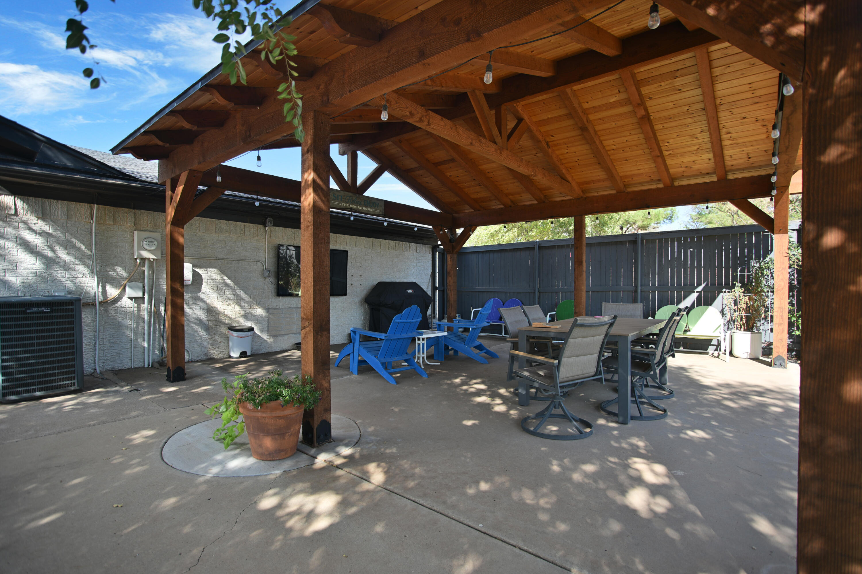 25 East Canyonview Drive Ransom Canyon, TX 79366 - Photo 54 of 58 a view of a patio with table and chairs under an umbrella with a barbeque