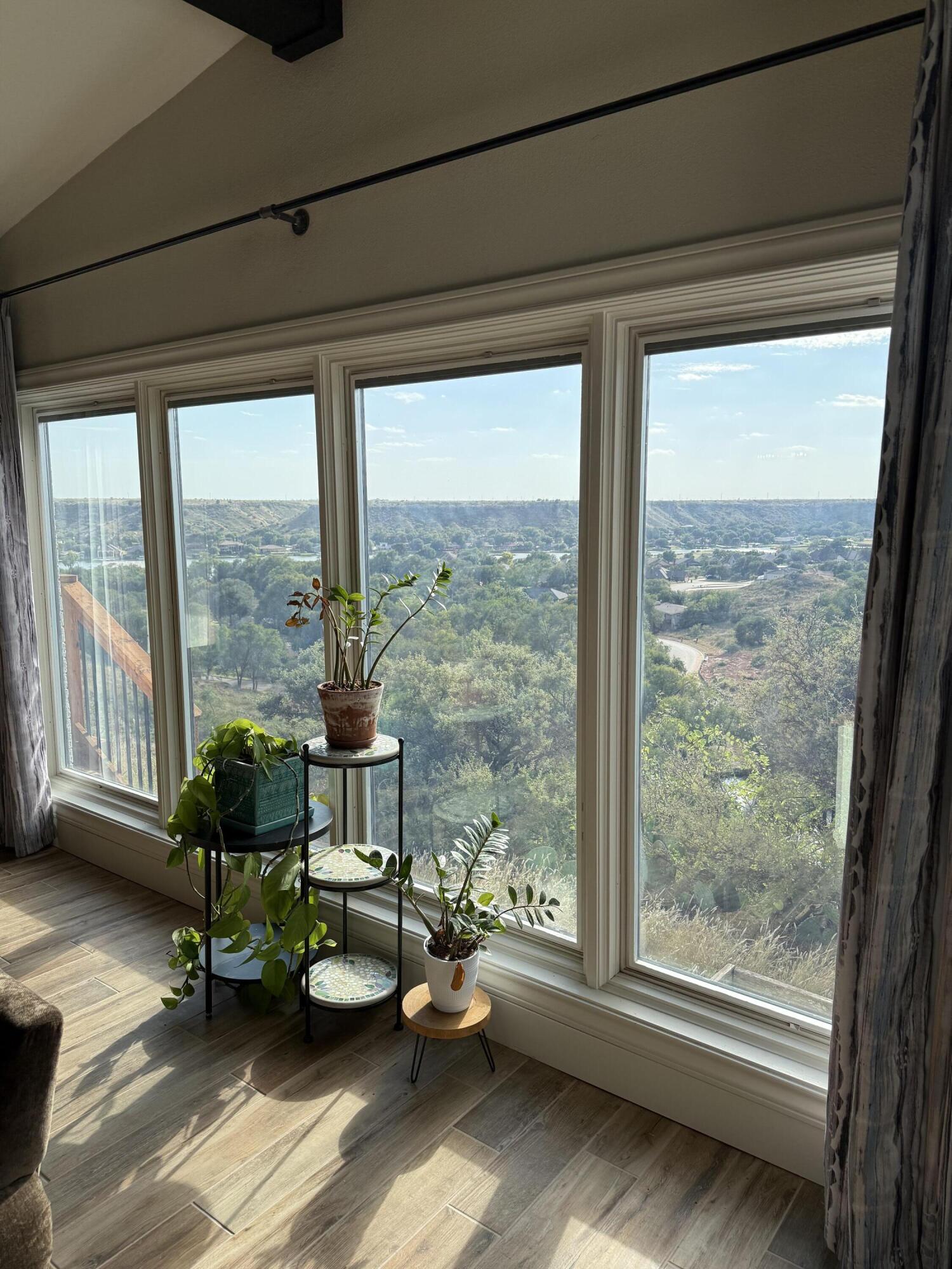 25 East Canyonview Drive Ransom Canyon, TX 79366 - Photo 7 of 58 a living room with furniture and floor to ceiling windows