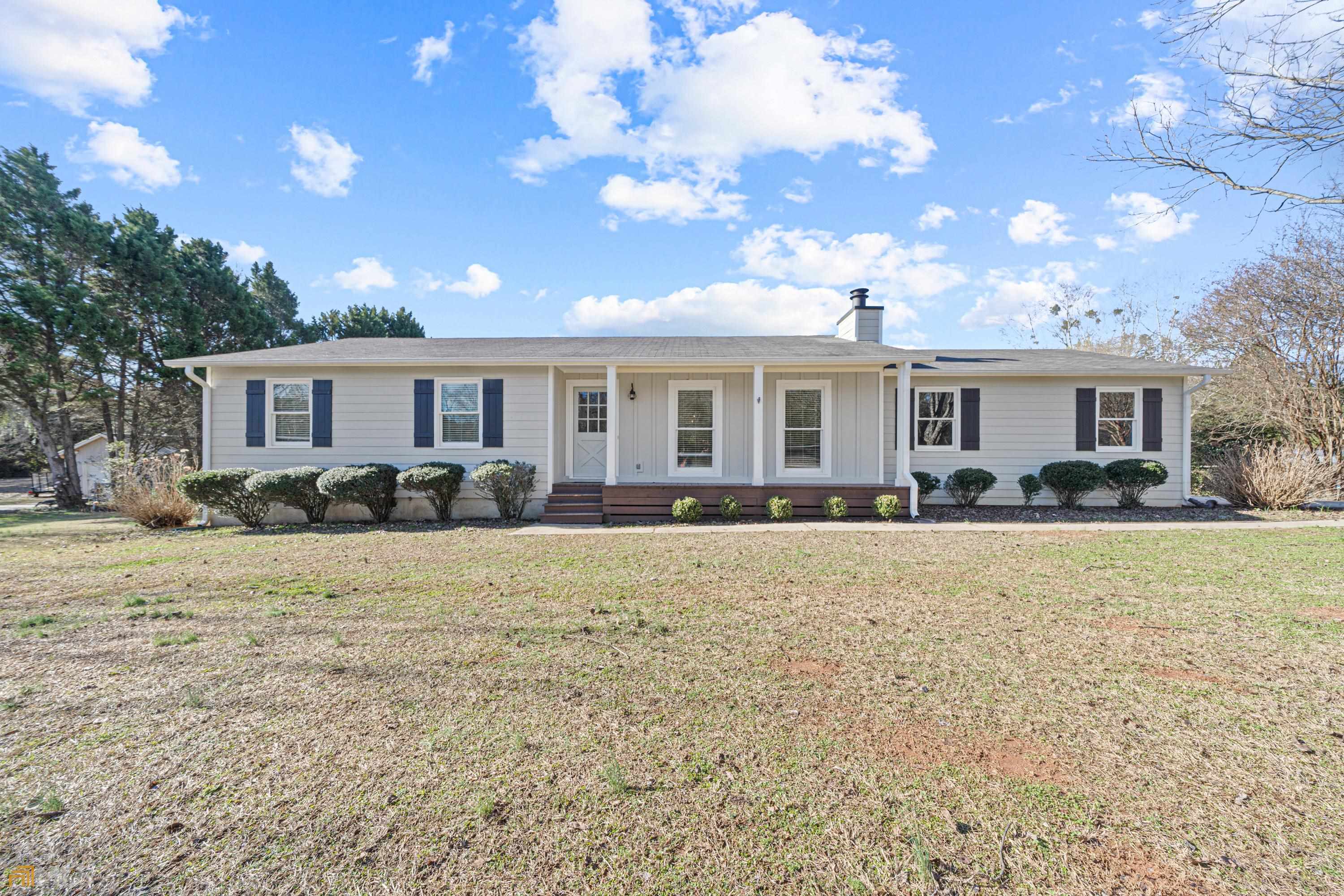 4240 Sandy Creek Road Madison, GA 30650 - Photo 1 of 1 a front view of a house with a yard