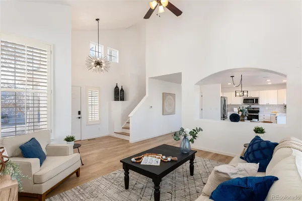 a living room with furniture and wooden floor