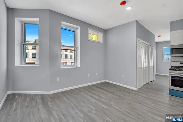 a view of livingroom with hardwood floor and kitchen view