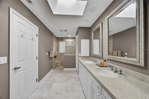 a bathroom with a double vanity sink mirror and shower