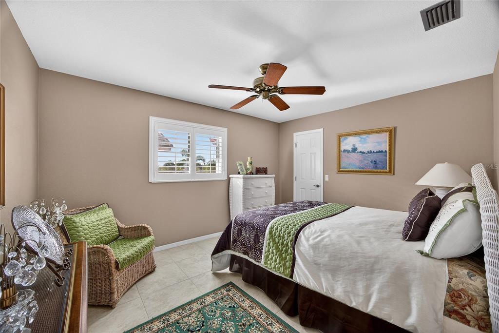 2855 Deborah Drive Punta Gorda, FL 33950 - Photo 19 of 41 a bedroom with a bed and a chandelier