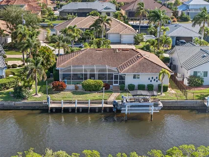 an aerial view of a house with lake view