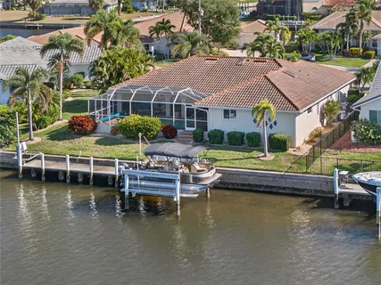 a view of house with swimming pool and outdoor seating