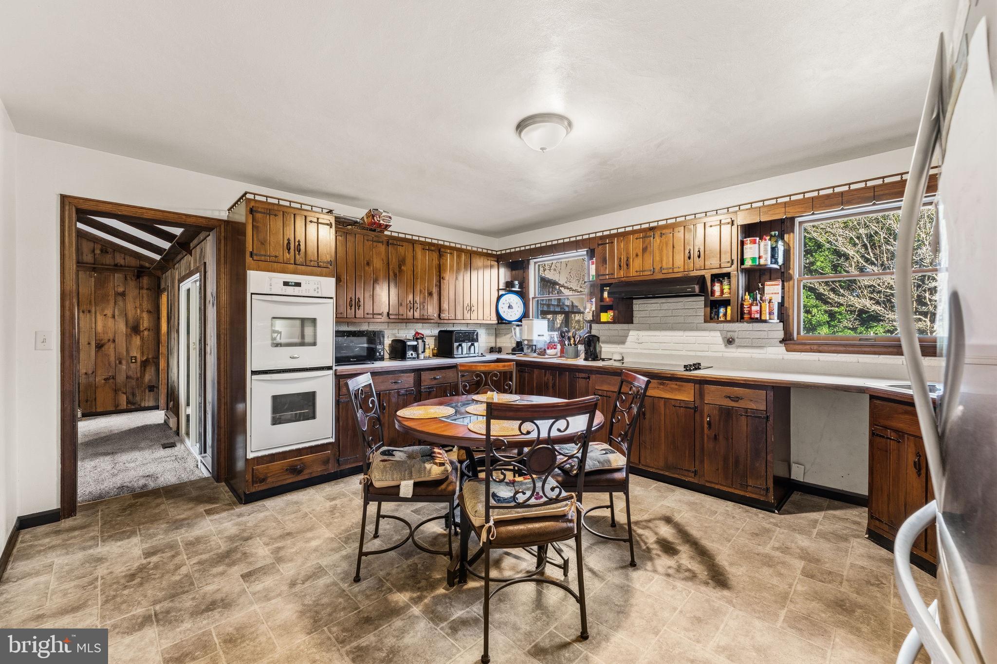 368 Appleton Road Elkton, MD 21921 - Photo 13 of 64 a dining area with a table chairs and a kitchen view